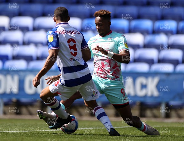 250421 - Reading v Swansea City - SkyBet Championship - Jamal Lowe of Swansea City is tackled by Andy Rinomhota of Reading
