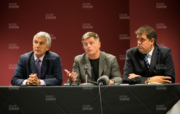 290814 - Regional Rugby Wales Press Conference, Liberty Stadium, Swansea - Gareth Davies, CEO of the Newport Gwent Dragons, left; Mark Davies, CEO of the Scarlets, centre, and Richard Holland, CEO of the Cardiff Blues, at a press conference to discuss the newly signed Rugby Services Agreement between the four Welsh Rugby Regions and the Welsh Rugby Union