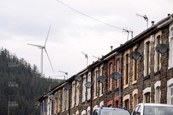 220422 - Picture shows a wind turbine overlooking houses in Gilfach Goch, South Wales, UK The renewable energy is key for providing green energy to homes in the area as the Welsh Government pushes to net zero carbon emissions by 2050