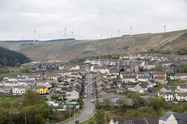 220422 - Picture shows a wind turbines overlooking houses in Gilfach Goch, South Wales, UK The renewable energy is key for providing green energy to homes in the area as the Welsh Government pushes to net zero carbon emissions by 2050