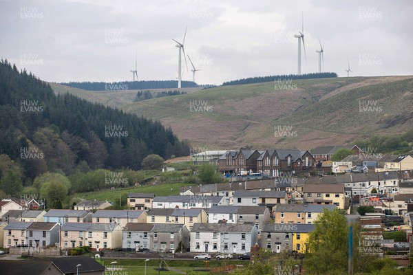 220422 - Picture shows a wind turbines overlooking houses in Gilfach Goch, South Wales, UK The renewable energy is key for providing green energy to homes in the area as the Welsh Government pushes to net zero carbon emissions by 2050