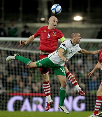 08.02.11 - Republic of Ireland v Wales - Carling Nations Cup -  Wales' James Collins heads the ball clear while being challenged by Ireland's Jonathan Walters 