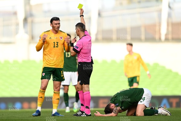111020 - Republic of Ireland v Wales - UEFA Nations League - Referee Anastasios Sidiropoulos shows Kieffer Moore of Wales a yellow card
