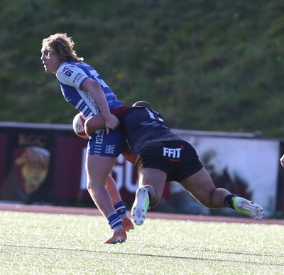 280226 - RGC v Bridgend - Super Rygbi Cymru (SRC) Plate Semi Final - Ben Burnell of Bridgend is tackled by Jesse Williams of of RGC