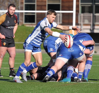 280226 - RGC v Bridgend - Super Rygbi Cymru (SRC) Plate Semi Final - Harvey Nash of Bridgend kicks the ball from the ruck