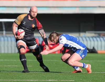 280226 - RGC v Bridgend - Super Rygbi Cymru (SRC) Plate Semi Final - Delwyn Jones of RGC is tackled by Ben Burnell of Bridgend 