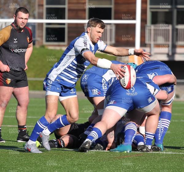 280226 - RGC v Bridgend - Super Rygbi Cymru (SRC) Plate Semi Final - Harvey Nash of Bridgend kicks the ball from the ruck