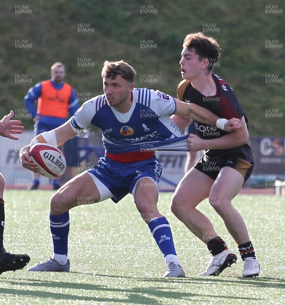 280226 - RGC v Bridgend - Super Rygbi Cymru (SRC) Plate Semi Final - Tommy Morgan of Bridgend is tackled by Tudor Jones of RGC
