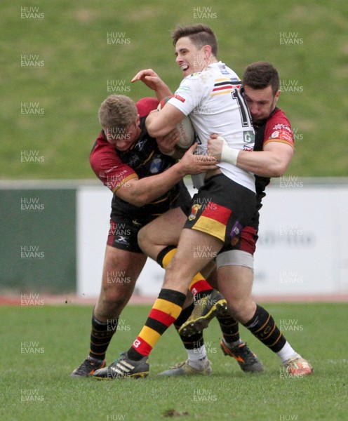 020319 - RGC v Carmarthen Quins - Principality Premiership -  Dale Ford of Carmarthen Quins is tackled by Billy McBryde and George Roberts of RGC