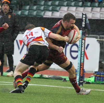 210226 - RGC v  Carmarthen Quins - Super Rygbi Cymru  Cup (SRC) - Sam Williams of RGC is tackled by Dylan Richards of Carmarthen Quins