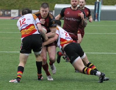 210226 - RGC v  Carmarthen Quins - Super Rygbi Cymru  Cup (SRC) - Danny Cross of RGC is tackled by Game McDonald of Carmarthen Quins