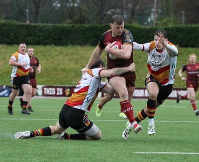 210226 - RGC v  Carmarthen Quins - Super Rygbi Cymru  Cup (SRC) - Dion Jones of RGC is tackled by Gabe McDonald of Carmarthen Quins