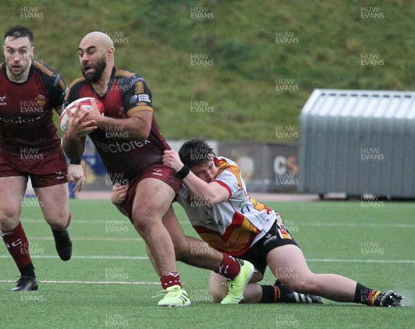 210226 - RGC v  Carmarthen Quins - Super Rygbi Cymru  Cup (SRC) - Jesse Williams of RGC is tackled by If an James of Carmarthen Quins