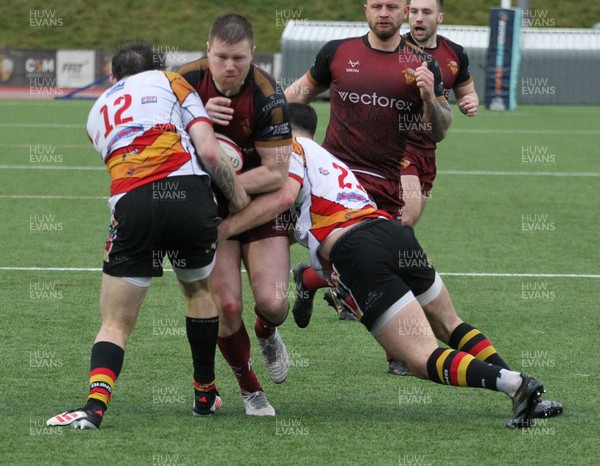 210226 - RGC v  Carmarthen Quins - Super Rygbi Cymru  Cup (SRC) - Danny Cross of RGC is tackled by Game McDonald of Carmarthen Quins