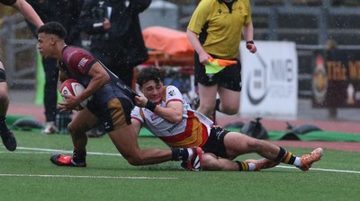 280326 - RGC v Carmarthen Quins - Super Rygbi Cymru (SRC) - Caio Parry of RGC is tackled by Bowen Clark of Carmarthen Quins