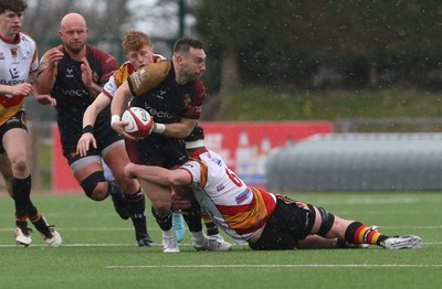 280326 - RGC v Carmarthen Quins - Super Rygbi Cymru (SRC) - Billy McBride of RGC is tackled by Iestyn Richards of Carmarthen Quins