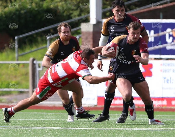270925 - RGC v Llandovery - Super Rygbi Cymru (SRC) - Dion Jones of RGC is tackled by Finn Thomas of Llandovery 
