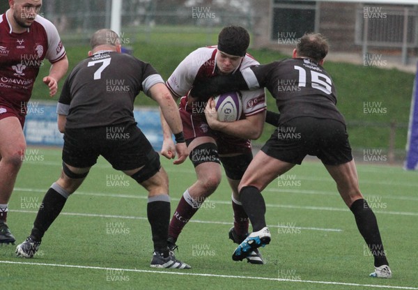 020324 - RGC v Neath - Indigo Group Premiership - Ilan Evans of Rgc is tackled by Ben Williams and Aaron Bramwell of Neath RFC