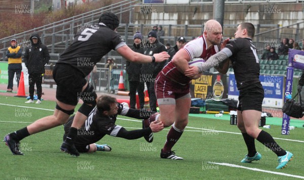 020324 - RGC v Neath - Indigo Group Premiership - Welwyn Jones of RGC is tackled by Cai Arnold and Louis Rees of Neath RFC