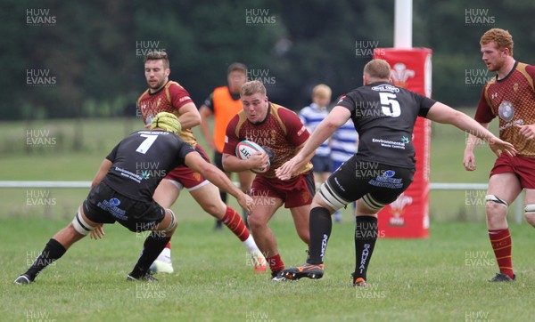 010918 - RGC1404 v Neath - Principality Premiership -  Evan Yardley of RGC is tackled by Jordan Collier and Scott Andrews of Neath