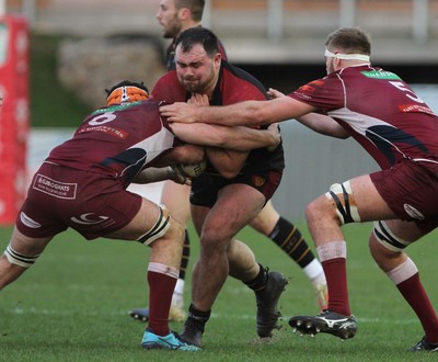 221218 - RGC1404 v Swansea - Principality Premiership -  Jordan Scott of RGC is tackled by William Griffiths and Morgan Morris of Swansea