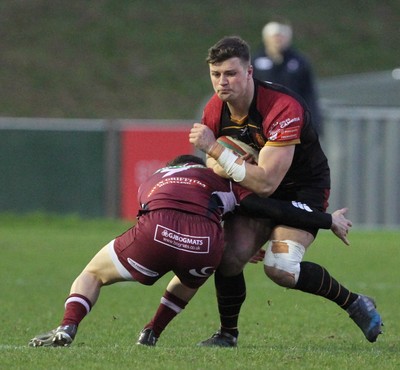 221218 - RGC1404 v Swansea - Principality Premiership -  Dion Jones of RGC is tackled by Mathew Aubrey of Swansea