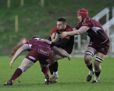 221218 - RGC1404 v Swansea - Principality Premiership -  Billy McBryde of RGC is tackled by Mathew Dodd and Jack Powell of Swansea