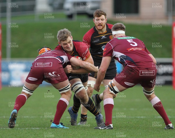 221218 - RGC1404 v Swansea - Principality Premiership -  Robin Williams of RGC is tackled by William Griffiths and Morgan Morris of Swansea