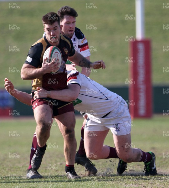 240218 - RGC1404 v Swansea - Principality Premiership - Tiaan Loots of RGC1404 is tackled by Mitch Walsh of Swansea RFC