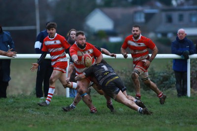 060124 - Rhiwbina v Ynysybwl - Admiral National League 1 East Central - Dewi Morris of Ynysybwl offloads from the tackle by Francis Perks of Rhiwbina 