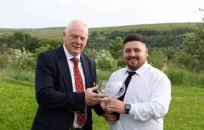 300526 - Rhymney RFC, Admiral National League 2 East Trophy Presentation - Colin Wilks, WRU National Council Member presents Rhymney RFC captain Tyler Evans with the league trophy after Rhymney win Admiral National League 2 East