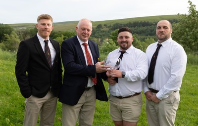 300526 - Rhymney RFC, Admiral National League 2 East Trophy Presentation - Colin Wilks, WRU National Council Member presents Rhymney RFC captain Tyler Evans with the league trophy, alongside Head Coach Lee Pearson, left, and Anthony Lott, forwards coach,after Rhymney win Admiral National League 2 East