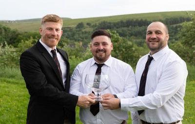 300526 - Rhymney RFC, Admiral National League 2 East Trophy Presentation - Rhymney RFC captain Tyler Evans with the league trophy, along with Head Coach Lee Pearson, left, and Anthony Lott, forwards coach, after Rhymney win Admiral National League 2 East