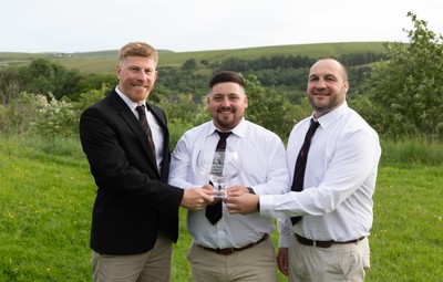 300526 - Rhymney RFC, Admiral National League 2 East Trophy Presentation - Rhymney RFC captain Tyler Evans with the league trophy, along with Head Coach Lee Pearson, left, and Anthony Lott, forwards coach, after Rhymney win Admiral National League 2 East