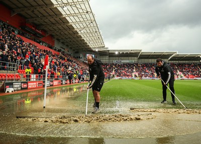 180323 - Rotherham United v Cardiff City - Sky Bet Championship - Groundsmen try and clear the pitch after the game is stopped due to a heavy downpour 