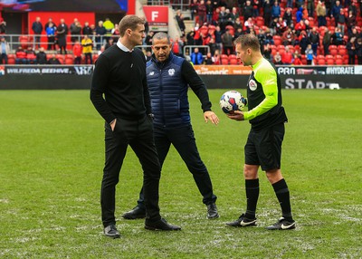 180323 - Rotherham United v Cardiff City - Sky Bet Championship - Cardiff Manager Sabri Lamouchi and Rotherham Manager Matt Taylor inspect the pitch with referee Oliver Langford after the game is stopped after a heavy downpour