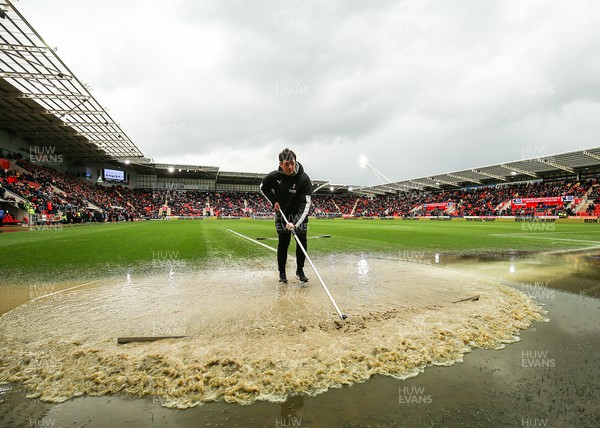 180323 - Rotherham United v Cardiff City - Sky Bet Championship - Groundsmen try and clear the pitch after the game is stopped due to a heavy downpour