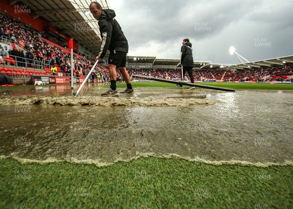 180323 - Rotherham United v Cardiff City - Sky Bet Championship - Groundsmen try and clear the pitch after the game is stopped due to a heavy downpour 