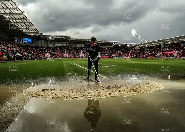 180323 - Rotherham United v Cardiff City - Sky Bet Championship - Groundsmen try and clear the pitch after the game is stopped due to a heavy downpour 