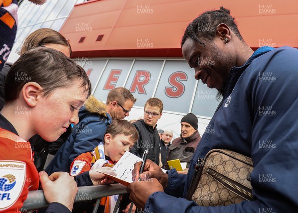 150423 - Rotherham United v Luton Town - Sky Bet Championship - Pelly Ruddock Mpanzu of Luton Town signs an autograph with a fan on his arrival to New York Stadium