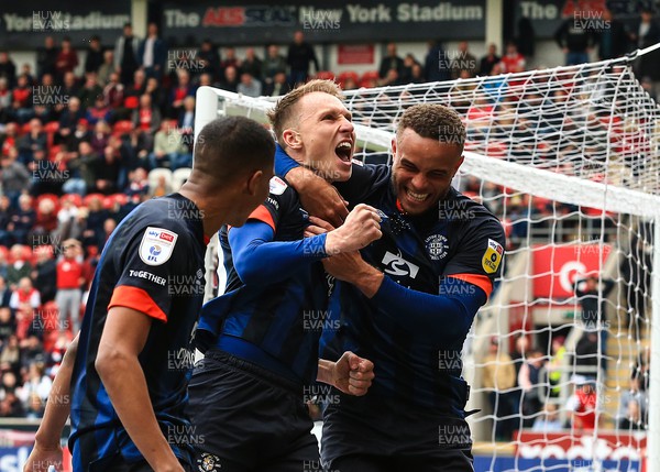 150423 - Rotherham United v Luton Town - Sky Bet Championship - Cauley Woodrow of Luton Town scores his sides second goal of the match from the penalty spot off a rebound save from Rotherham Goalkeeper Josh Vickers and celebrates with team mates