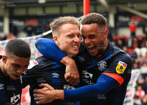 150423 - Rotherham United v Luton Town - Sky Bet Championship - Cauley Woodrow of Luton Town scores his sides second goal of the match from the penalty spot off a rebound save from Rotherham Goalkeeper Josh Vickers and celebrates with team mates