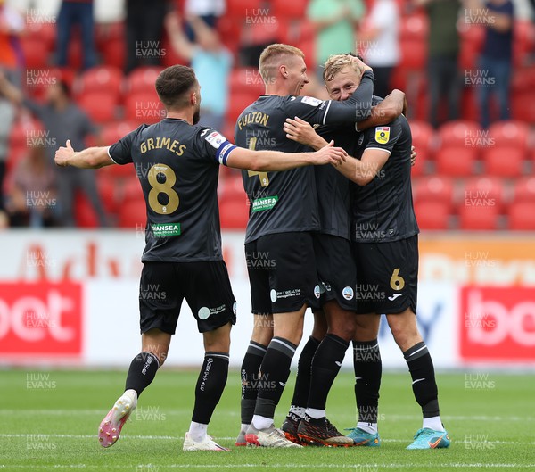 300722 - Rotherham United v Swansea City - Sky Bet Championship - Harry Darling of Swansea celebrates with Kyle Naughton, Jay Fulton and Matt Grimes after shooting from mid field to score the Swans' 1st goal
