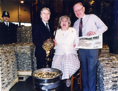 050292 - Picture shows Joyce Beynon celebrating her Pools win with husband Doug and TV star Adam Faith in the Royal Mint, Llantrisant