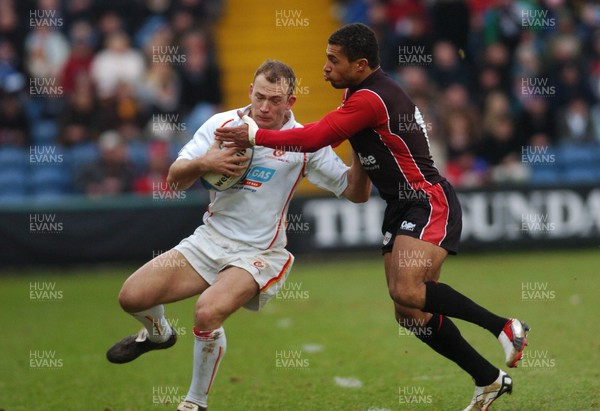 150106 - Heineken Cup Rugby Sale Sharks v Newport Gwent Dragons  Dragons' Richard Fussell is tackled by Jason Robinson 