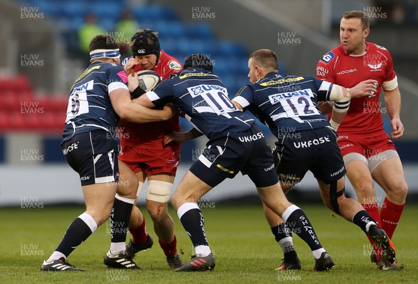 210117 - Sale Sharks v Scarlets - European Rugby Champions Cup - James Davies of Scarlets is tackled by Laurence Pearce, Josh Charnley and Mark Jennings of Sale Sharks by Chris Fairweather/Huw Evans Agency