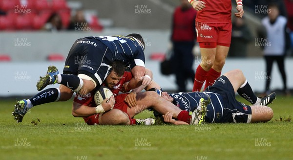 210117 - Sale Sharks v Scarlets - European Rugby Champions Cup - Rob Evans of Scarlets is tackled by Kieran Longbottom and Cameron Neild of Sale Sharks by Chris Fairweather/Huw Evans Agency