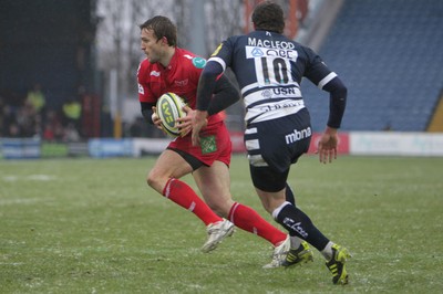 04.02.12 - Sale Sharks v Scarlets - LV= Cup.Scarlets' Andy Fenby is put under pressure from Sale's Nick Macloed.