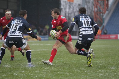 04.02.12 - Sale Sharks v Scarlets - LV= Cup.Scarlets' Andy Fenby is put under pressure from Sale's Nick Macloed and Rob Miller.