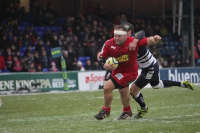 04.02.12 - Sale Sharks v Scarlets - LV= Cup.Scarlets' Peter Edwards is tackled by Sale's Nick Macloed.